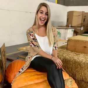 Nicole Rosen sitting on a pumpkin on the set of Halloween Wars